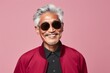 © Markus Schröder - Portrait of a satisfied asian elderly man in his 90s wearing a trendy sunglasses in solid color backdrop