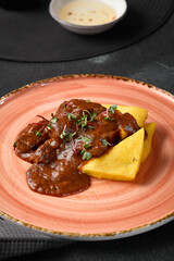 Sticker - Rustic Polenta with Beef Cheeks Gourmet Dish on Pink Plate with Warm Lighting and Artistic Presentation