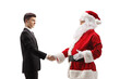 © Ljupco Smokovski - Young man in a suit and tie shaking hands with santa claus
