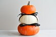 © Viam - Festive pumpkin stack with black ribbon for Halloween decor