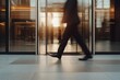 © BOONJUNG - Business Professional Walking in Modern Workplace
