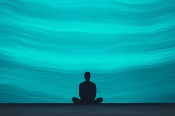 Silhouette of a person meditating against a serene blue abstract background.