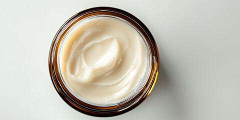 Wall Mural - Open glass jar of white skincare cream product against white background.