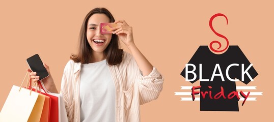 Young woman with credit card, mobile phone and shopping bags on beige background. Black Friday sale