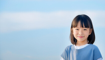 Minimal portrait of a Japanese happy little girl standing and smiling
