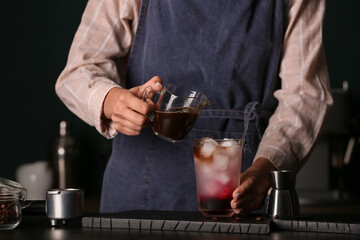 Wall Mural - Female barista making cold brew coffee at table, closeup