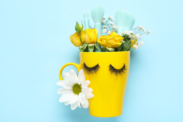 Wall Mural - Creative composition with ceramic cup, false eyelashes, makeup brushes and flowers on color background