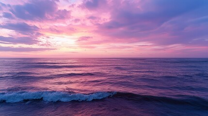 Aufkleber - The ocean is calm and the sky is a beautiful shade of pink. The water is a deep blue color
