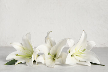 Beautiful white lily flowers on light table