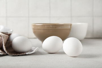 Raw chicken eggs on white table