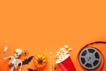 Sticker - Composition with popcorn, film reel and Halloween decorations on color background