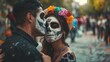 © VK Studio - A couple with painted faces in traditional Day of the Dead makeup share an intimate moment on a festive street, capturing cultural celebration and love.