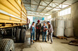 © Marko Geber - Group of diverse farmers talking in tractor shed