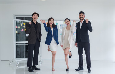 Business team people woman and man asian group standing hand up look successful cooperate to plan marketing idea new project with in agreement ready for happiness working inside room office company