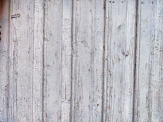 The textured surface of aged white wood features distinct grooves, creating a rustic backdrop suitable for adding text or graphics