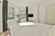 © ADDICTIVE STOCK - Bright bedroom interior with a view of urban street