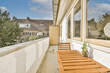 © ADDICTIVE STOCK - Sunny suburban apartment balcony with wooden furniture