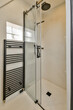 © ADDICTIVE STOCK - Modern bathroom with glass shower and towel heater