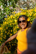 © ADDICTIVE STOCK - Joyful woman among yellow flowers in Amsterdam