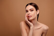 © Beauty Hero - Photo of adorable pretty lady wear nothing arm cheek apply skin lotion empty space isolated brown color background