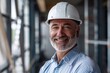 © LukaszDesign - Portrait of a pleased designer and project manager in an office setting, focused on construction and industrial planning while wearing a safety helmet