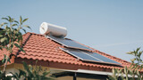 A solar water geyser on the roof of a house with red tiles