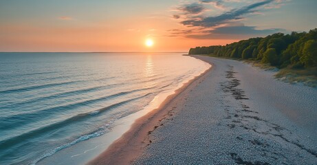 A serene beach at sunset, with soft waves lapping at the shore and a line of trees on the horizon.