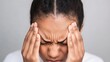 © Kunalai - Close-up of a person gripping their temples in frustration, ache, headache from stress
