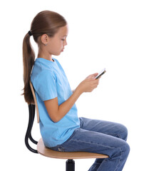 Wall Mural - Girl with correct posture and smartphone sitting on chair against white background