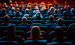 © Eddy Drmwn - Rear view of a crowd of people sitting in an auditorium, watching a show.