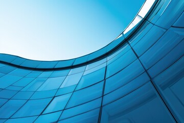 Looking up at modern architecture with curved blue glass walls. Abstract perspective of futuristic building design. Low angle camera of swirling modern architectural building and blue sky. AIG51.