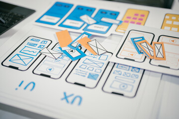 Ux designers are discussing during a meeting about user experience and user interface layout for application development