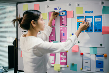 female ux ui designer is arranging a wireframe application layout development template for a mobile 