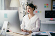 © Parichat - Young asian businesswoman typing on her computer at home office, showing dedication and confidence in the digital business world