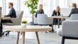 © Preecha - A high-end boardroom setup with modern furniture and business professionals sitting around a conference table, engaging in a meeting. The image is captured with deep depth of field, leaving ample