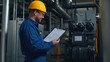 © Arpatsara - An engineer reviews a checklist in a factory, wearing a hard hat and safety glasses, ensuring safety and compliance.