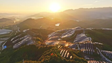 Wall Mural - Aerial photography of solar photovoltaic panels，sunset over the mountains