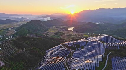 Wall Mural - Aerial photography of solar photovoltaic panels，sunset over the mountains