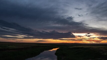 Wall Mural - Beautiful colorful sunrise over the river, red and yellow flashes. Ripples On Water Surface Of Sea Or Lake At sunrise.