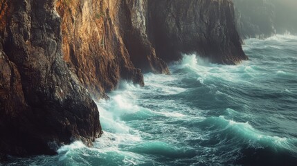 Wall Mural - The ocean is rough and the waves are crashing against the rocks