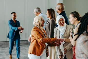 Wall Mural - diverse professionals exchanging handshakes and greetings at a lively business conference event