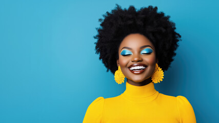 stylish black woman with afro hairstyle smiling with eyes closed, she is wearing yellow turtleneck sweater and earrings and blue eye shadow make-up