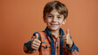 © Tengkwa - Thumbs Up, Big Smile: A young boy with a bright smile gives a confident double thumbs up, radiating positive energy and playful charm. His casual.