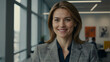 © Tengkwa - Confident Businesswoman Portrait:  A smiling businesswoman exudes confidence and professionalism in a modern office setting. Her warm smile and direct gaze convey approachability and success.