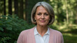 © Tengkwa - Confident Woman in Nature: Portrait of a mature woman with short gray hair, exuding confidence and serenity amidst a lush green forest backdrop.