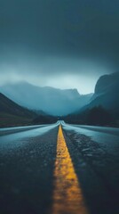 Poster - A road with a yellow line and mountains in the background