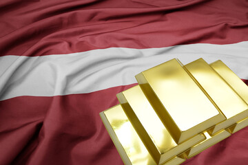 shining golden bullions on the latvia flag background.