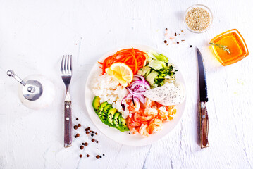 Wall Mural - Lunch diet - rice, shrimp, avocado in one plate on a light background