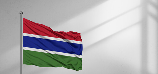 Wall Mural - The Gambia national flag cloth fabric waving on beautiful window light grey Background.