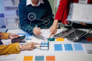 Wall Mural - close up view of ui developer team brainstorming on their project with laptop, smartphone and digita